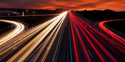 Speed Traffic - light trails on motorway highway at night, long exposure abstract urban background